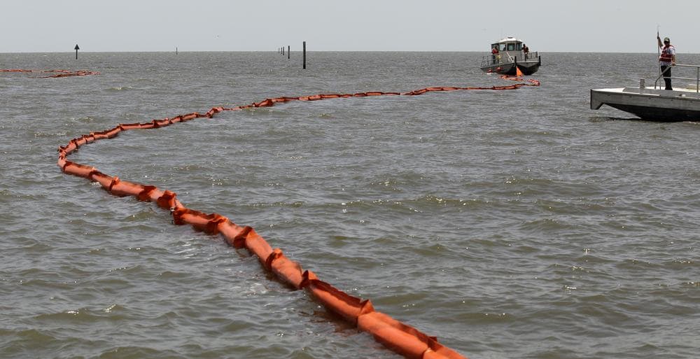 A boat pulls a boom into the Gulf of Mexico at Biloxi, Miss. Friday. The community was bracing for a possible land fall of an oil spill caused by the explosion of BP's Deepwater Horizon oil platform more than three weeks ago. (AP Photo/Charlie Riedel)