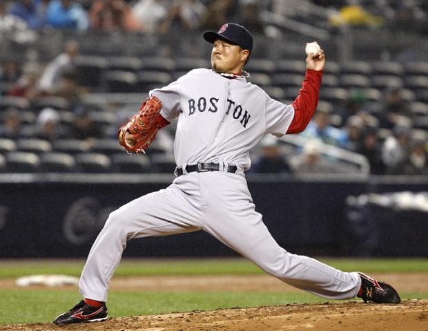 Boston reliever Hideki Okajima winds up in the eighth inning of the Red Sox's 7-6 victory over New York in a baseball game in New York on Tuesday. (AP)