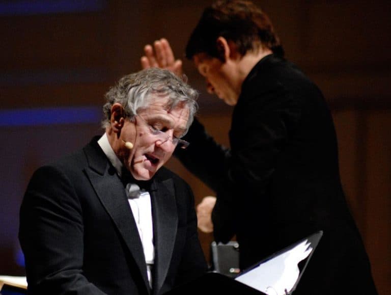 Actor Robert De Niro, foreground, reads while the Pops&#039; Keith Lockhart conducts during Tuesday&#039;s &quot;The Dream Lives On&quot; premiere. (Michael J. Lutch) (Click to enlarge)
