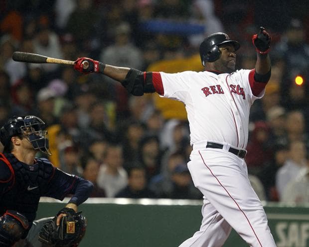 Boston's David Ortiz follows through on a two-run home run in front of Minnesota's Joe Mauer in the fourth inning of the game on Wednesday in Boston. (AP)