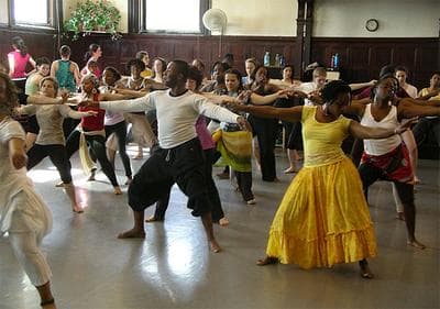 Jean Appolon, center, leads a recent Haitian dancing class in Cambridge&#39;s Central Square. (Chris Burrell for WBUR)