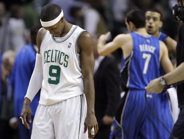 Boston guard Rajon Rondo walks off the court as Orlando guard J.J. Redick and teammates celebrate a 96-92 overtime win in Game 4 in the NBA Eastern Conference finals in Boston on Monday. (AP)