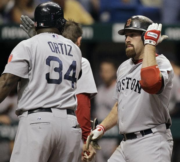 Boston's Kevin Youkilis celebrates with teammate David Ortiz after hitting a fourth inning, two-run home run off Tampa Bay pitcher Lance Cormier during a game Monday in St. Petersburg, Fla. (AP)