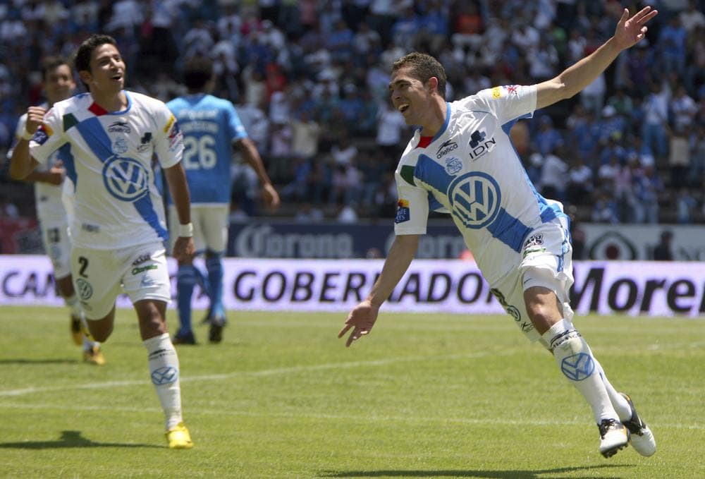 Herculez Gomez, right, celebrates his goal during a Mexican soccer league match against Cruz Azul in Puebla, Mexico, in April. (AP)