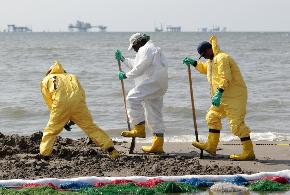 Workers clean up oil residue along the beach in Port Fourchon, La., Saturday, May 29, 2010. (AP Photo/Jae C. Hong)