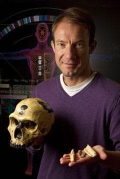 University of California Santa Cruz’s Ed Green holds replicas of the bones, and a skull, from which Neanderthal DNA was extracted. (Science/AP)