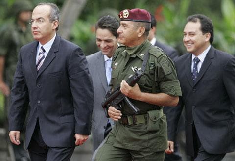 Mexican President Felipe Calderon, left, escorted by an army honor guard and his top aides, arrives at a ceremony to commemorate the Mexican-American War and the &quot;Child Heroes&quot; or Heroic Cadets in Mexico City, Sept. 13, 2006. (AP)