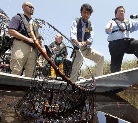 Louisiana Gov. Bobby Jindal, center, tours the oil impacted marsh of Pass a Loutre, La. on Wednesday, May 19, 2010. Oil from the Deepwater Horizon oil spill is infiltrating the coast of Louisiana. (AP)