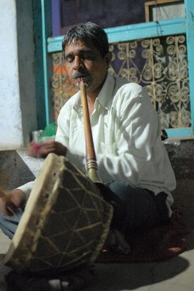 Sheru Mayuddin plays an oboe-like instrument called the Shehnai and the drums as he waits for his nephew to take over the drums. (Jill Ryan)