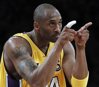Kobe Bryant points during the first half of the Los Angeles Lakers&#039; Game 2 victory over the Phoenix Suns on Wednesday. (AP Photo/Chris Carlson)