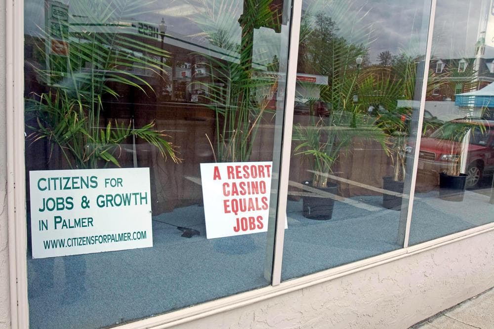 There are signs like these, in a store front on Palmer&#39;s Main Street, all over town &mdash; expressing both support for and opposition to a casino in town. (Lisa Tobin/WBUR) 