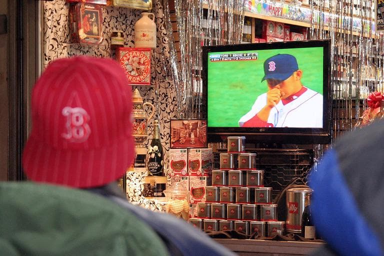 The club members watch the game on the flat screen inside Cardullo's display window. (Andrew Phelps/WBUR)