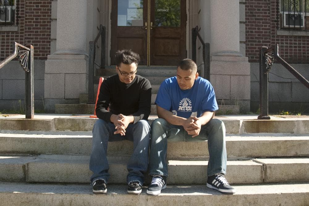 Ricky Le, left, and Johnny Chheng talk on the steps of the Lowell Courthouse. (Jess Bidgood for WBUR)