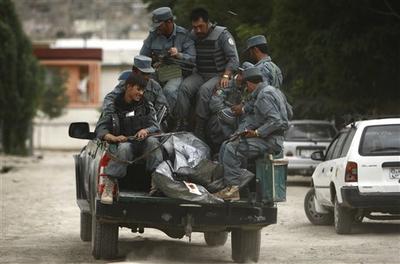 Police officers leave with the two bodies of alleged Taliban militants who were killed in a gunbattle in Kabul, Afghanistan. (AP)