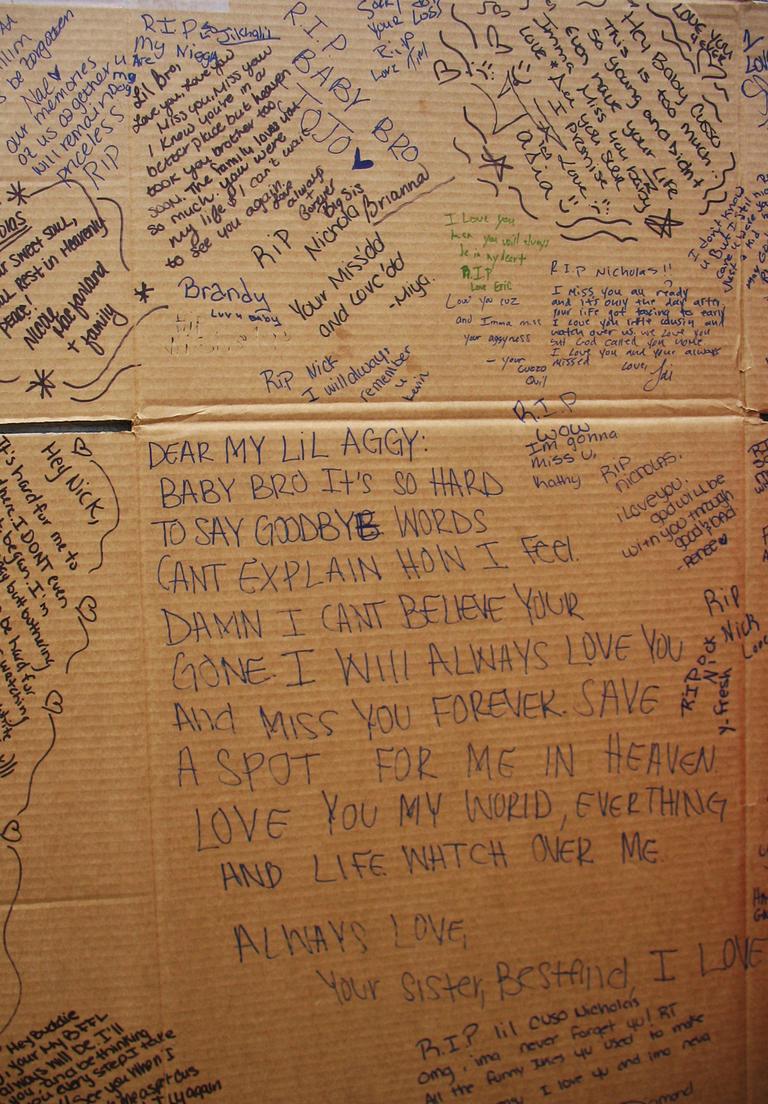 Friends and family of Nicholas Fomby-Davis wrote goodbyes to him on a flattened cardboard box. Click to enlarge. (Bianca Vazquez-Toness/WBUR)