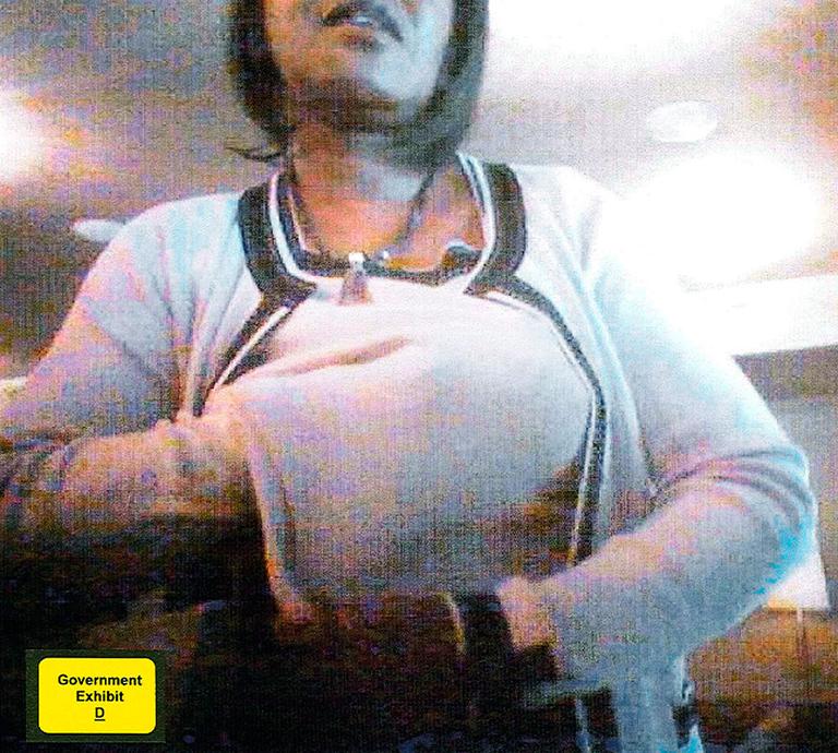 This screenshot allegedly shows former state Sen. Dianne Wilkerson, D-Boston, stuffing bribe money under her sweater on June 18, 2007, at No. 9 Park restaurant in Boston. (AP/U.S. Attorney&#39;s Office)
