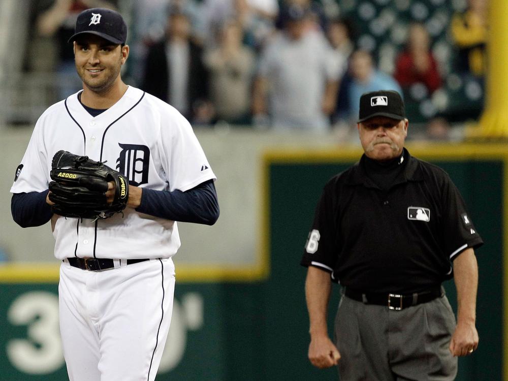 Detroit Tigers pitcher Armando Galarraga walks away from first base umpire Jim Joyce, who called Cleveland Indian Jason Donald safe Wednesday. The highly contested call resulted in Galarraga&#39;s loss of a perfect game. (AP)