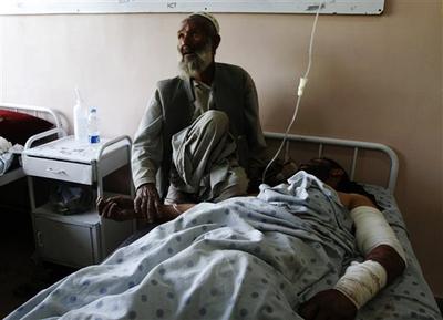 An unidentified father comforts his injured son at a hospital following a blast at wedding party in Kandahar city, Afghanistan, on Thursday. (AP)