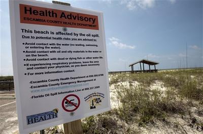 Health advisory signs were posted at the entrance to Perdido Key, Fla., beaches after oil began washing up. (AP)