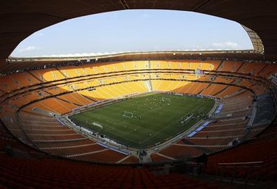 South Africa practices before an empty stadium during the final training session for the soccer World Cup. (AP)