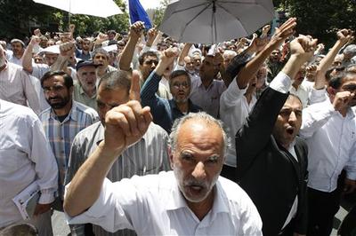 Iranian worshippers chant pro-government slogans after Friday prayers in Tehran on June 11, 2010. (AP)