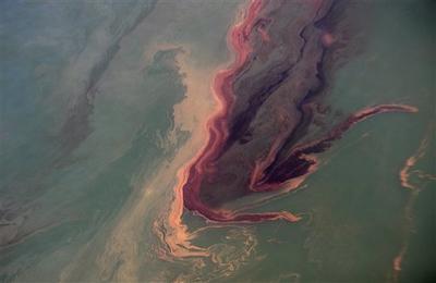 An oil slick is near the site of the Deepwater Horizon oil spill contrasts with the water in the Gulf of Mexico.  (AP)