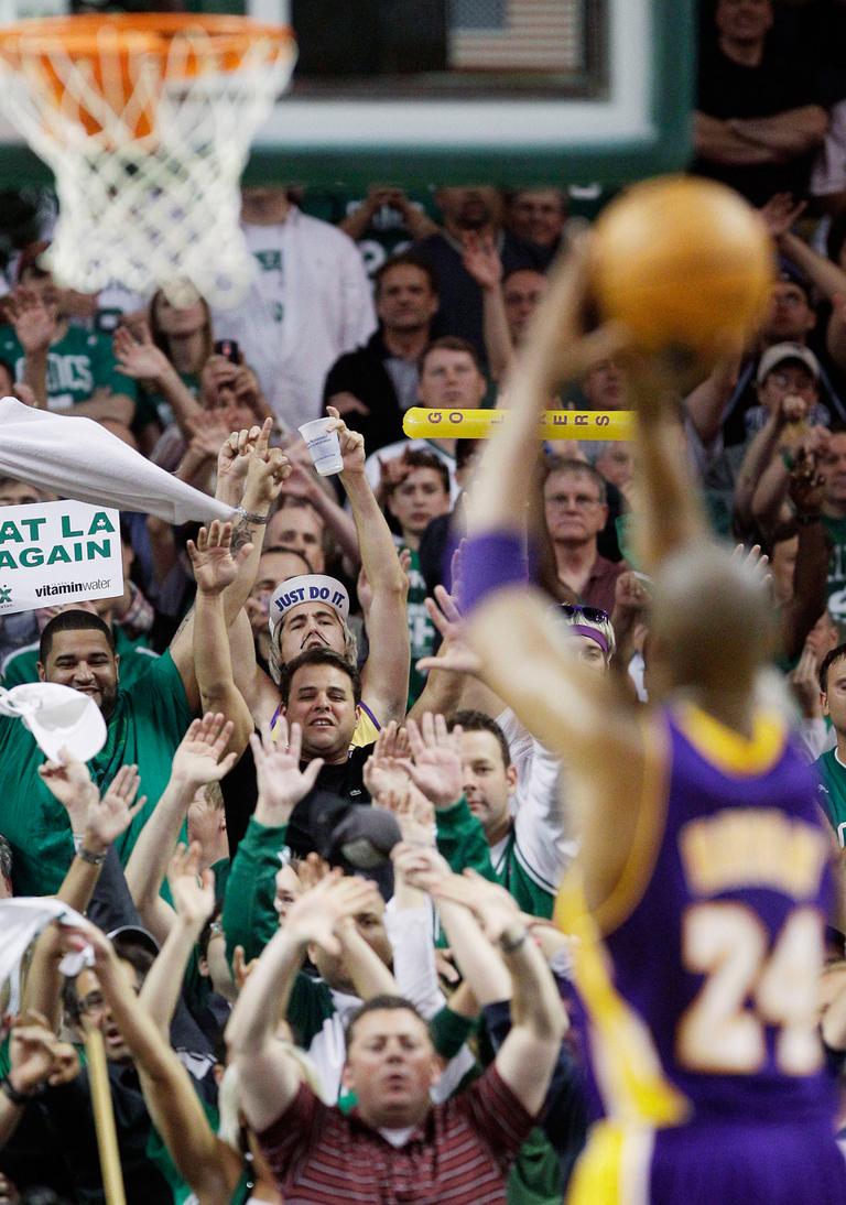 Celtics fans try to distract LA Lakers guard Kobe Bryant as he shoots a free throw during Game 5 of the NBA finals on Sunday. (AP)
