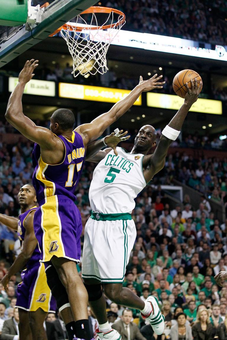Celtics forward Kevin Garnett eludes Lakers center Andrew Bynum to score in Game 5 Sunday in Boston. (AP)