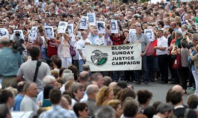 Relatives and families join members of the bogside area holding pictures of victims aloft, as they gather to march to the Guildhall for a preview of the just-released Saville report into the 1972 Bloody Sunday Shootings, in Londonderry, Northern Ireland.(AP)