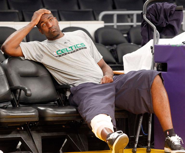 Boston Celtics&#39; Kendrick Perkins, who injured his knee in Game 6, sits out of practice Wednesday in LA. (AP)