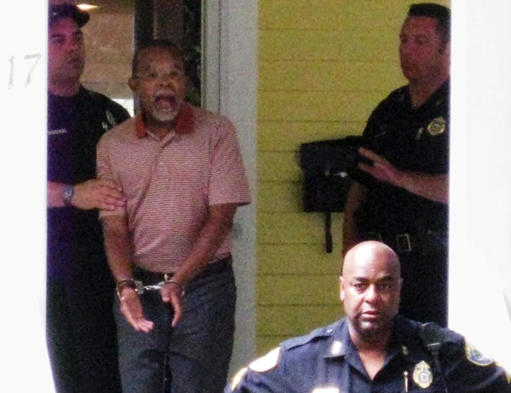 In this photo taken by a neighbor on July 16, 2009, Henry Louis Gates, Jr. is arrested at his Cambridge home. (AP) 