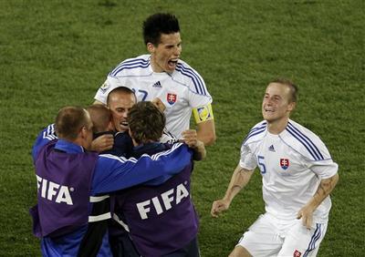 Slovakia&#039;s Marek Hamsik, top left, and Slovakia&#039;s Miroslav Stoch, right, celebrate with team members after winning the World Cup group F soccer match between Slovakia and Italy at Ellis Park Stadium in Johannesburg, South Africa. (AP)