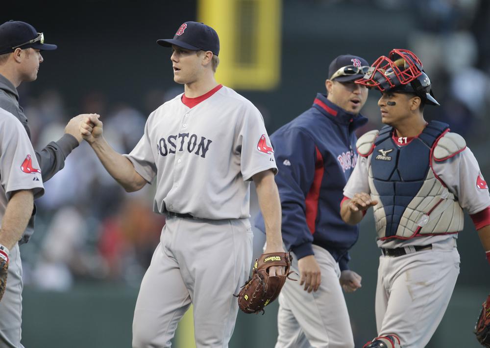 Sox relief pitcher Jonathan Papelbon, left, and catcher Victor Martinez, right, celebrate with teammates after a 4-2 victory against the Giants on Saturday. (AP)