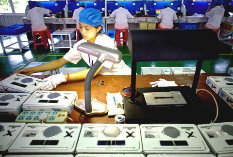 A Chinese worker checks solar-powered products at a factory in Baoding, north China&#039;s Hebei province, in 2009. (AP)