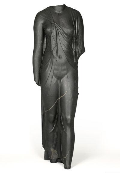 Cut in hard, dark stone, this feminine body has a startlingly sculptural quality. Complete, it must have been slightly larger than life-size. The statue is certainly one of the queens of the Ptolemaic dynasty (likely Arsinoe II) dressed as the goddess Isis, as confirmed by the knot that joins the ends of the shawl the woman wears, which was representative of the queens during this time period. The statue was found at the site of Canopus. (Credit: Franck Goddio / Hilti Foundation)