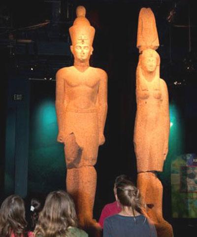 The Colossus King and Queen from Heracleion dwarf these young visitors. (Lisa Godfrey / The Franklin Institute)