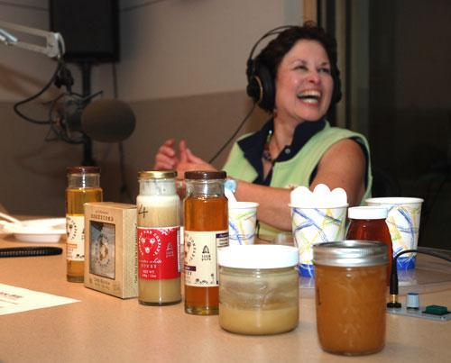 Beekeeper Jane Wild in the On Point studio, with varieties of honey, including her own. (WBUR/Jeff Carpenter-Jesse Costa)