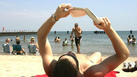 A reader on the beach along Lake Michigan. (AP)
