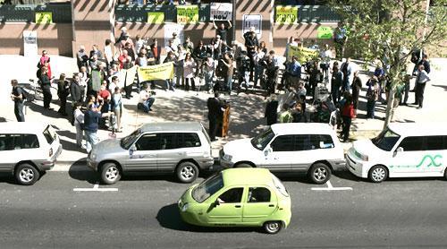 A small electric car passes other electric vehicles parked at a rally in support of electric vehicles outside the California Environmental Protection Agency in Sacramento, Calif. (AP)