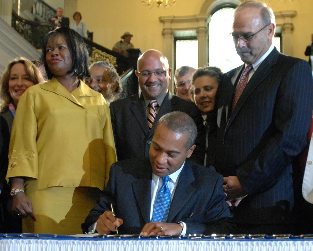 State Sen. Dianne Wilkerson stands next to Gov. Deval Patrick as he signs a bill repealing the law that disallowed out-of-state gay couples from marrying in Massachusetts, in July 2008. To their right, then-House Speaker Salvatore DiMasi. (AP)