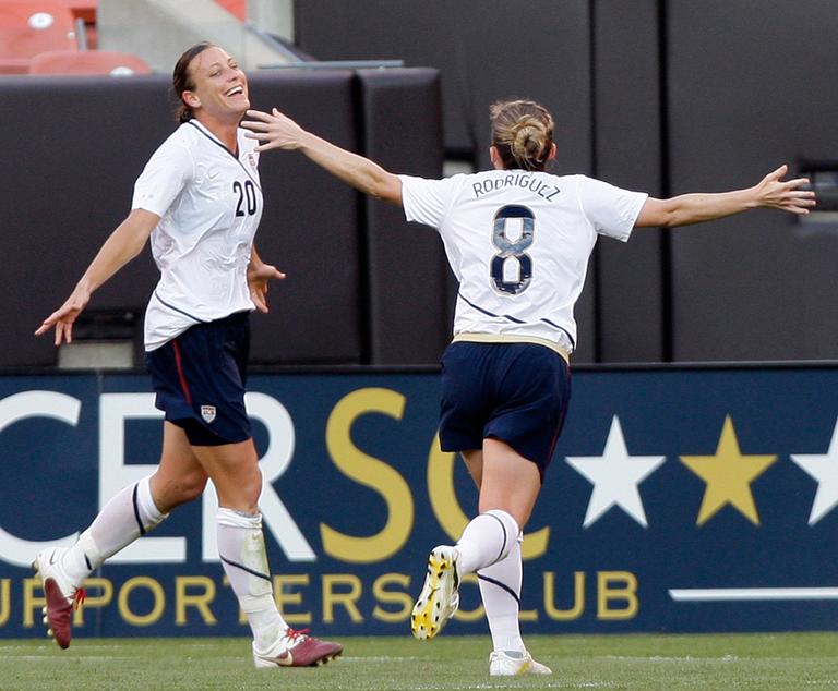 Abby Wambach (20) celebrates a U.S. Soccer goal with teammate Amy Rodriguez in a match in May. Wambach chose her &quot;side&quot; in the WPS All-Star Game. (AP)