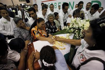 Relatives and friends of Rodolfo Torre, candidate for governor of the northern Mexican state of Tamaulipas, touch his coffin during his funeral, in Ciudad Victoria, Mexico. Gunmen ambushed Torre&#039;s campaign caravan in June, four other&#039;s were killed: three of the candidate&#039;s bodyguards and a state lawmaker. (AP)