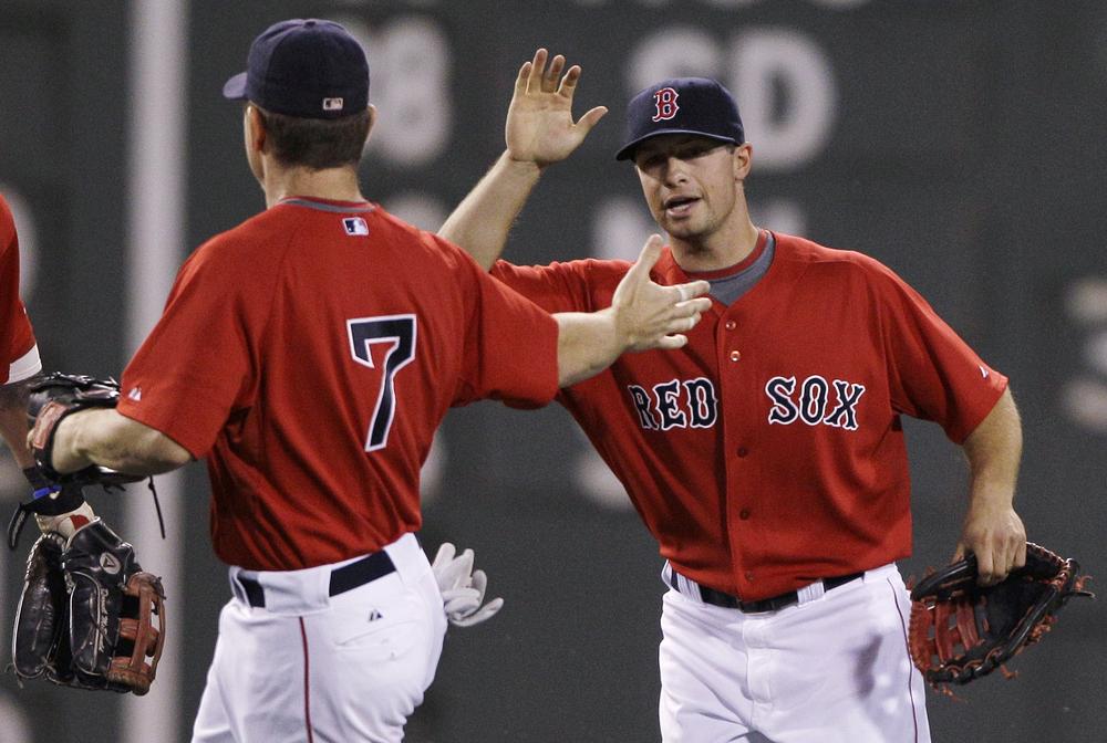 Daniel Nava, right, and  J.D. Drew celebrate a 3-2 win over the Orioles, Friday.  Drew had two solo home runs and Nava had an RBI single, which broke a 2-2 tie, in the Red Sox win.(AP Photo/Charles Krupa)