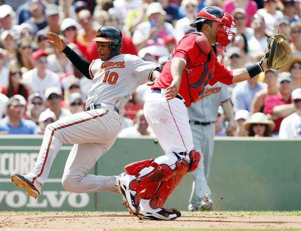Baltimore's Adam Jones scores as Boston's Gustavo Molina waits for a throw in the fourth inning of the game on Sunday in Boston. (AP)