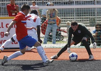 England&#039;s goalkeeper saves a shot from a Russian player during last year&#039;s Homeless World Cup soccer tournament in Milan, Italy.  (AP)