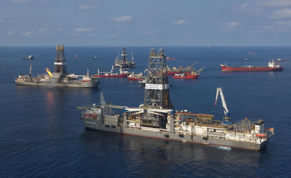 The Transocean Discoverer Inspiration, foreground, arrives at the sight of the Deepwater Horizon to install a &quot;capping stack&quot; on the well Saturday, July 10, 2010 in the Gulf of Mexico. (AP Photo/BP, Marc Morrison)
