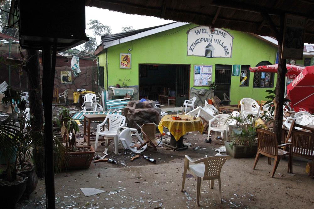 Damaged chairs and tables amongst the debris strewn outside the Ethiopian Village restaurant in Kampala, Uganda, on Monday after an explosion at the restaurant late Sunday. (AP)