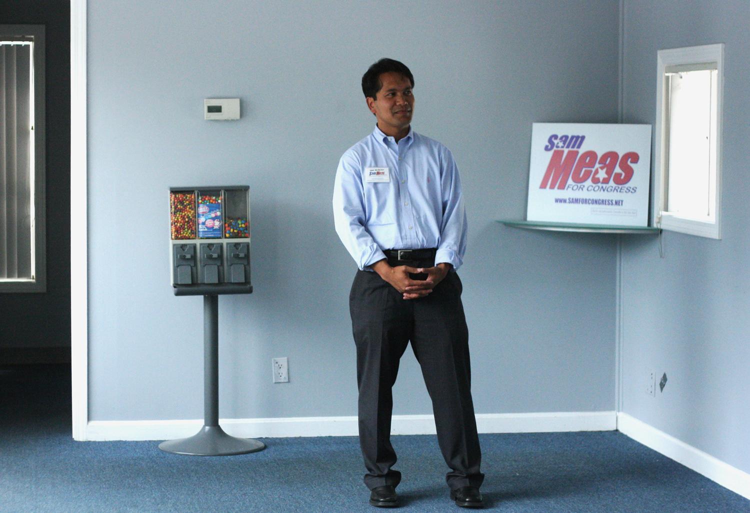 Sam Meas stands in a brand-new, empty campaign office in Lowell. (Jess Bidgood for WBUR)