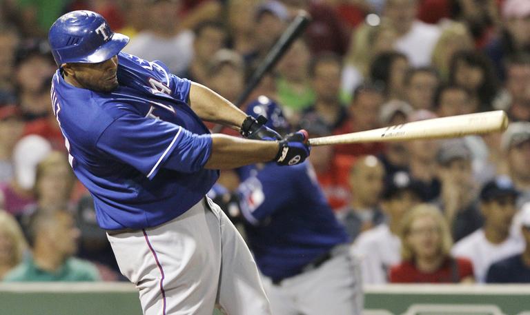 Texas Rangers&#39; Nelson Cruz follows through on a single against the Boston Red Sox during the fifth inning of their baseball game in Boston, Thursday, July 15, 2010. (AP)