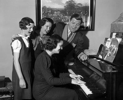 Babe Ruth and his family celebrate his 40th birthday in New York in 1934. The family is shown around a piano, though not the piano Sudbury, Ma. resident Kevin Kenney has searched for. (AP)
